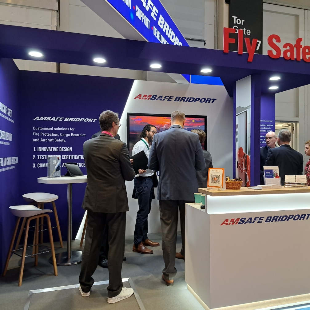 Visitors to the amsafe bridport bespoke exhibition stand design