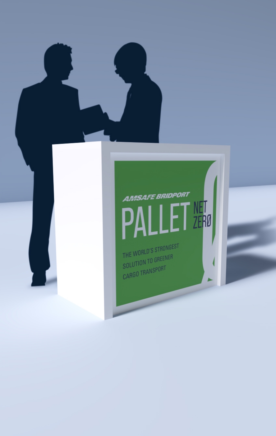 Silhouetted figures shake hands beside a white display with a green panel that reads PALLET NET ZERO, promoting greener cargo transport.