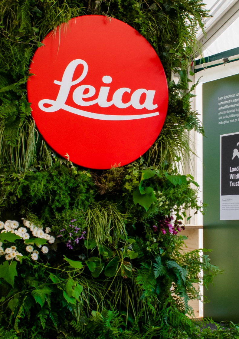 Close-up of a living wall feature within a Leica bespoke exhibition stand, showcasing biophilic design and natural texture integration.