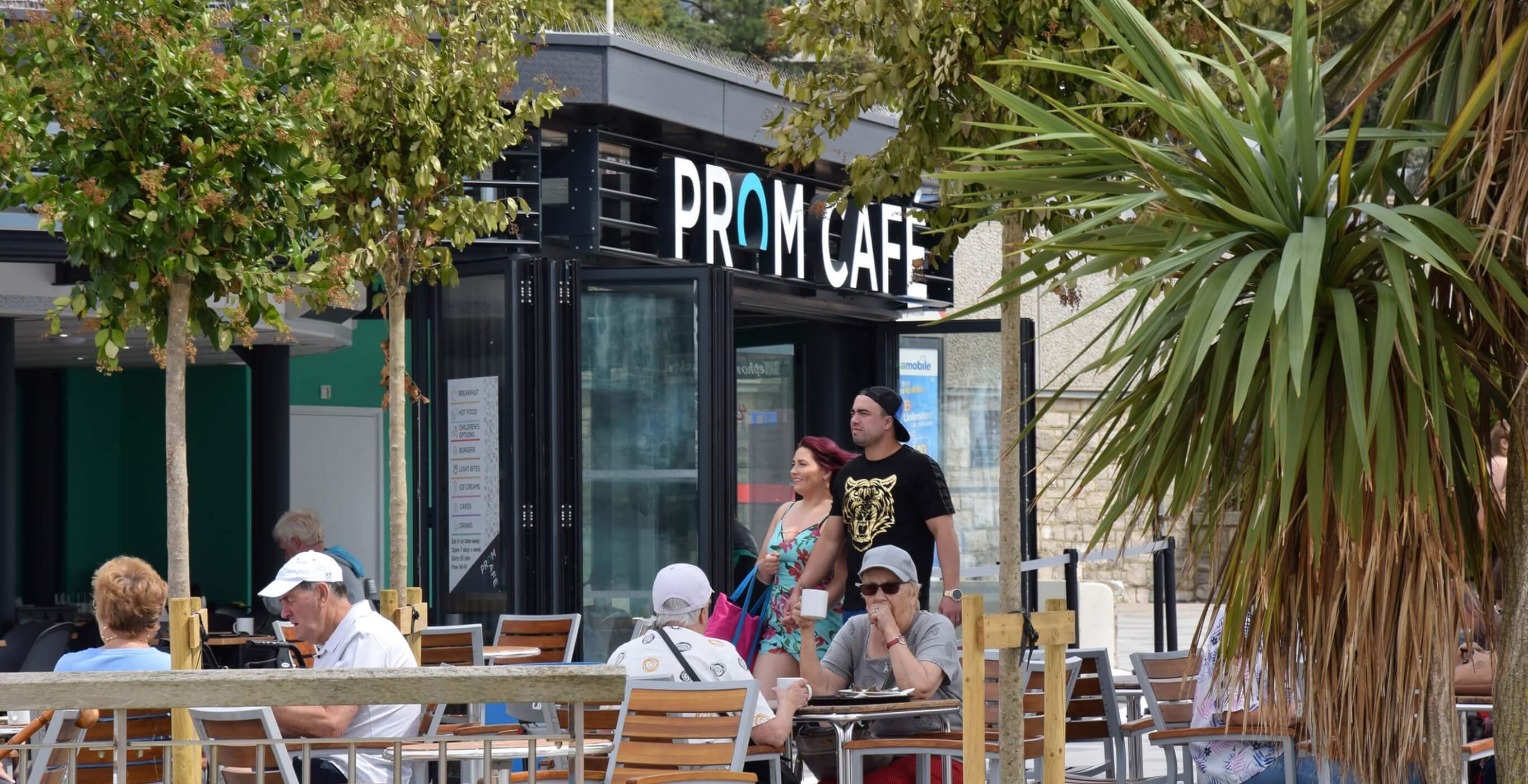 Prom Cafe exterior seating area design highlighting spatial design, branded environments and cohesive custom signage integration.