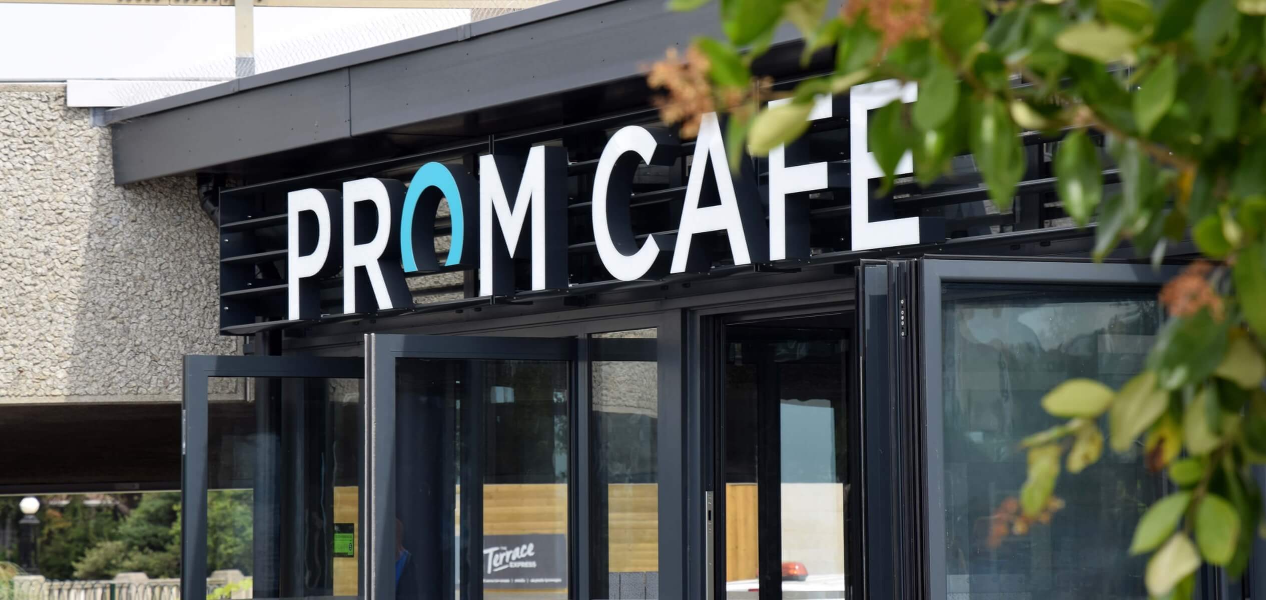 Exterior signage for Prom Cafe demonstrating custom signage design, spatial branding and cohesive exhibition stand visuals.